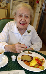 resident enjoying her meal