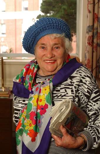 woman proudly holding newspaper