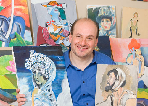 Robert, holding artwork painted by his mother Dina Loeva.