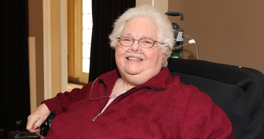 Judy Freespirit with white hair and an oxygen cannula in her nostrila