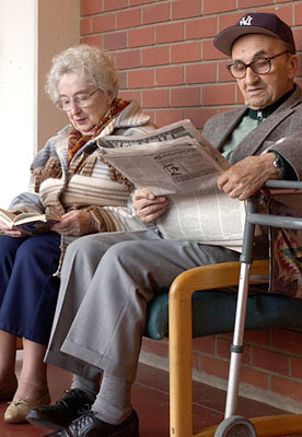 Two elders reading in the galleria at the Jewish Home