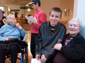 two students and two residents at an intergenerational program