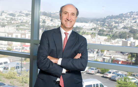 Mark Myers in front of window overlooking San Francisco